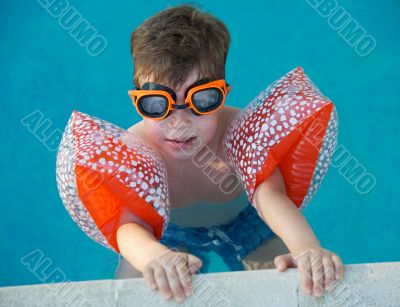 boy learning to swim