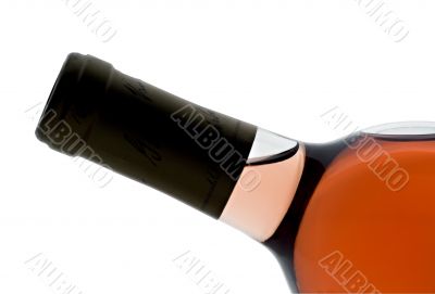 Single bottle of backlit blush wine tilted