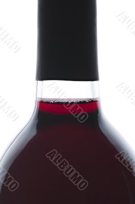 Single bottle of backlit red wine