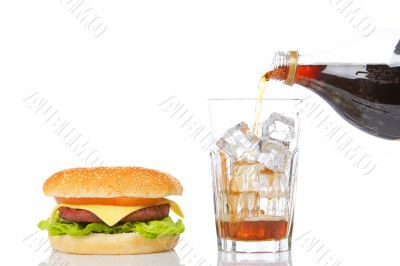 Cheeseburger and pouring soda