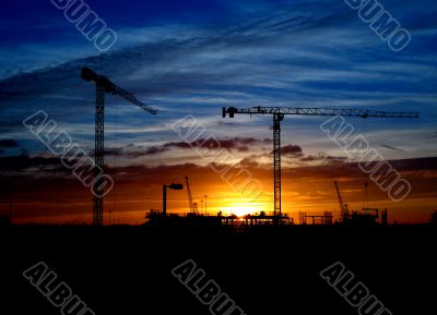 Cranes and construction site silhouette