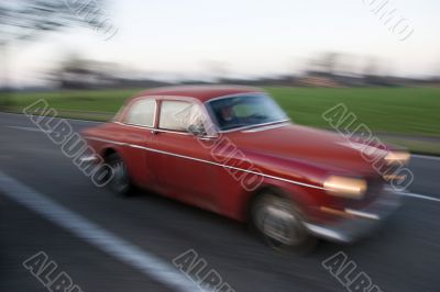 a vintage automobile at speed