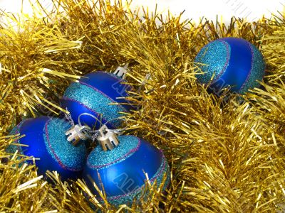 Christmas blue ornaments and gold tinsel