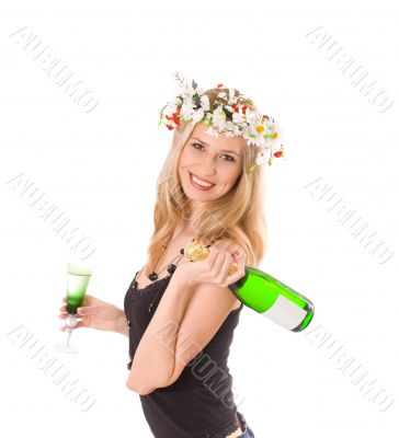 Smiling blond in colorful wreath holding glass and bottle