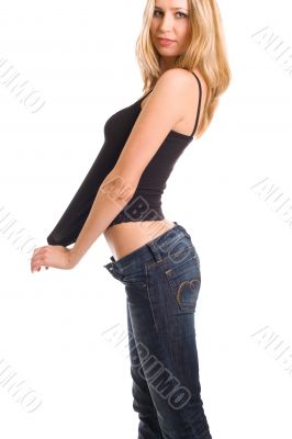 Lovely girl in blue jeans pulling black shirt