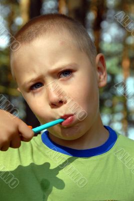 boy is brushing his teeth