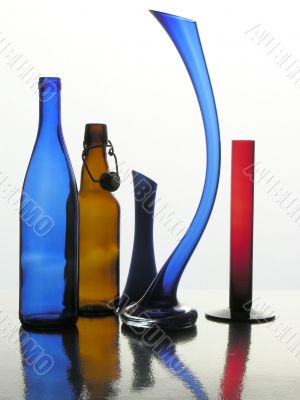 still life of multicolor glass vases and bottles