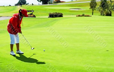 Lady in red jacket putting