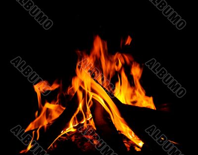 An intense log burning fire with red hot flames