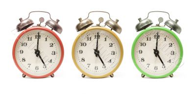 3 colored alarm clocks isolated