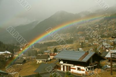 Rainbow across alpine village