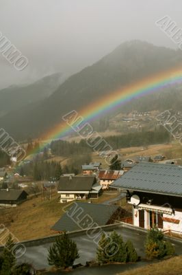 Rainbow across alpine village