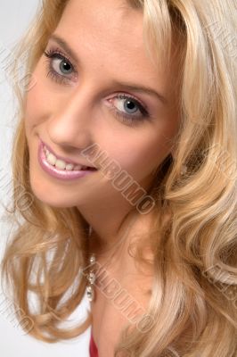 Studio portrait of a long blond girl flirting