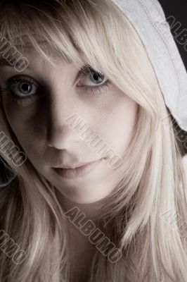 Studio portrait of a long blond girl in pain