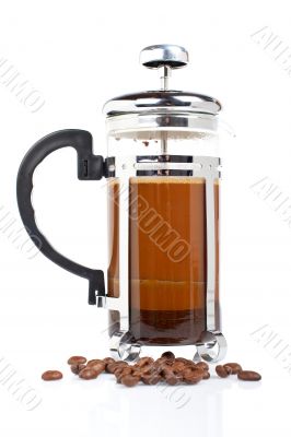 A coffee pot with beans