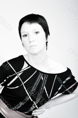 Studio portrait of a young woman with short hair in a fashion po
