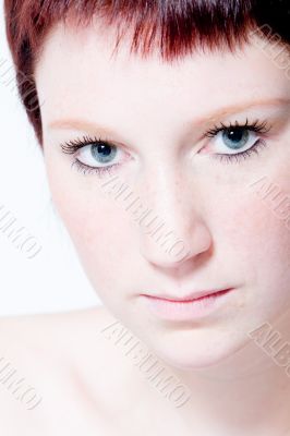 Studio portrait of a young woman with short hair making eye cont