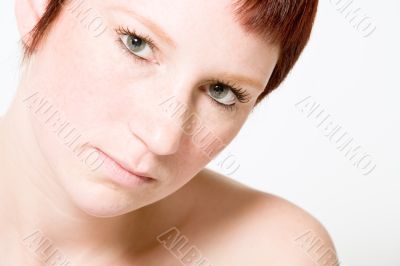 Studio portrait of a questionable looking young woman with short