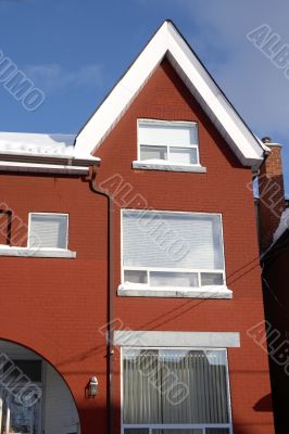 Snowed red-bricked townhouse in downtown Toronto