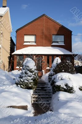 Snowed red-bricked house in downtown Toronto