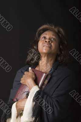 Woman Holding Bible White Sleeves