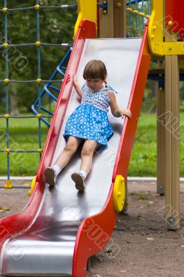 Girl sliding on playground