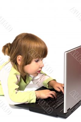Child typing message from laptop