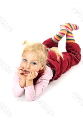 Pensive girl lying on the floor