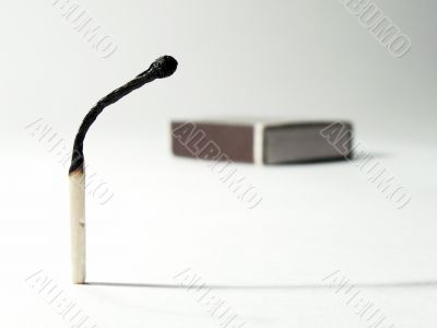 Burnt match and match-box