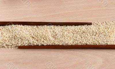 Sesame corn on a wooden plate with sticks
