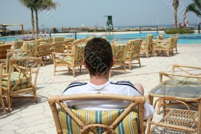 Relaxation in an armchair near pool