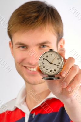 guy with an alarm clock in hands
