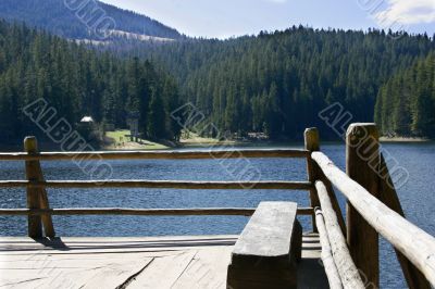 wooden bench on lake shore