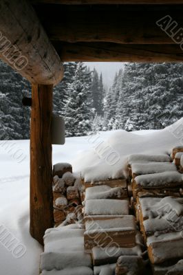 Wood pile under mountain hut