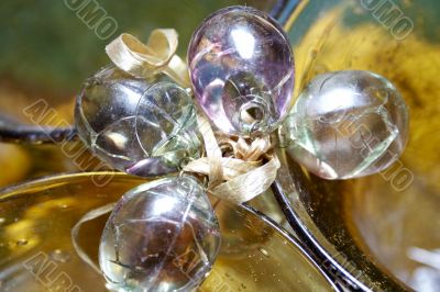 Close-up of yellow wineglass and chrystal grapes