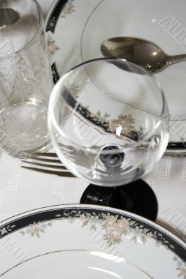 Close-up of served table with wineglass and plates Close-up of served table with wineglass and plates