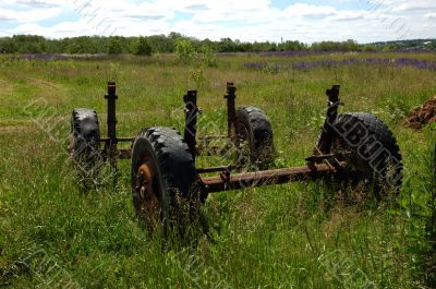 Old wheels of trailer on the meadow