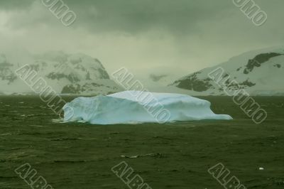 Iceberg glowing in an overcast dawn Iceberg glowing in an overcast dawn