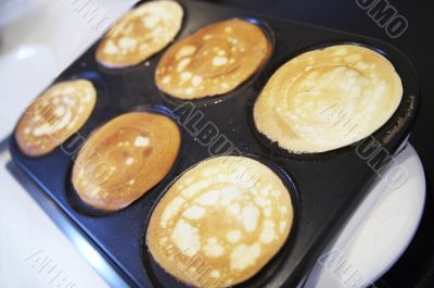 breakfast with six pancakes on electric oven