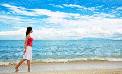 red dress girl strolling on the beach red dress girl strolling on the beach