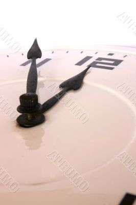 Clock showing five minutes to twelve