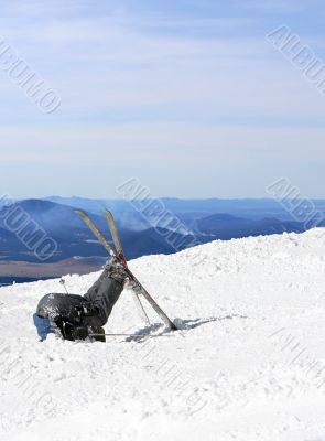 skier buries his head in the snow