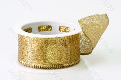 A spool of golden girft wrapping ribbon