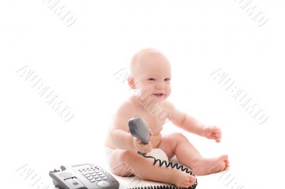 Little smiling baby with telephone receiver in hand over white Little smiling baby with telephone receiver in hand over white