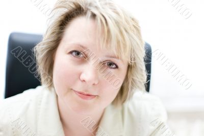 Mid-life business woman in office look at camera
