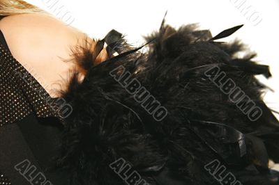 women`s shoulder with black feather boa