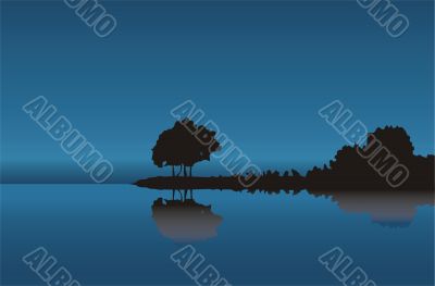 Silhouette of a tree at dark blue coast
