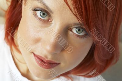beautician is doing make-up to red-haired woman beautician is doing make-up to red-haired woman