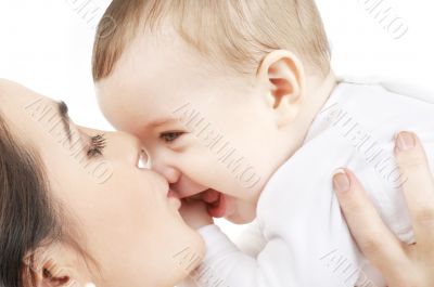 happy mother kissing baby boy