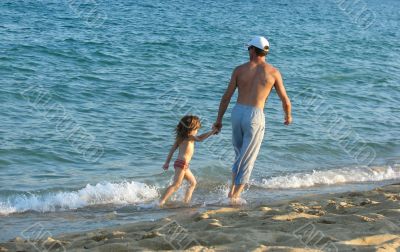  father and the daughter on a beach